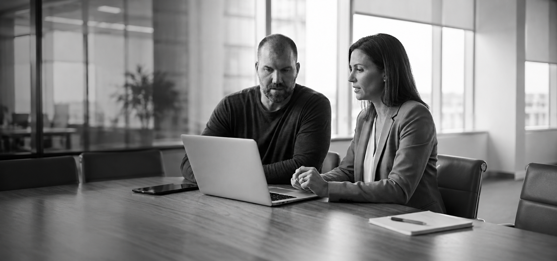 Business owners reviewing marketing plan with DV Freelance Marketing logo